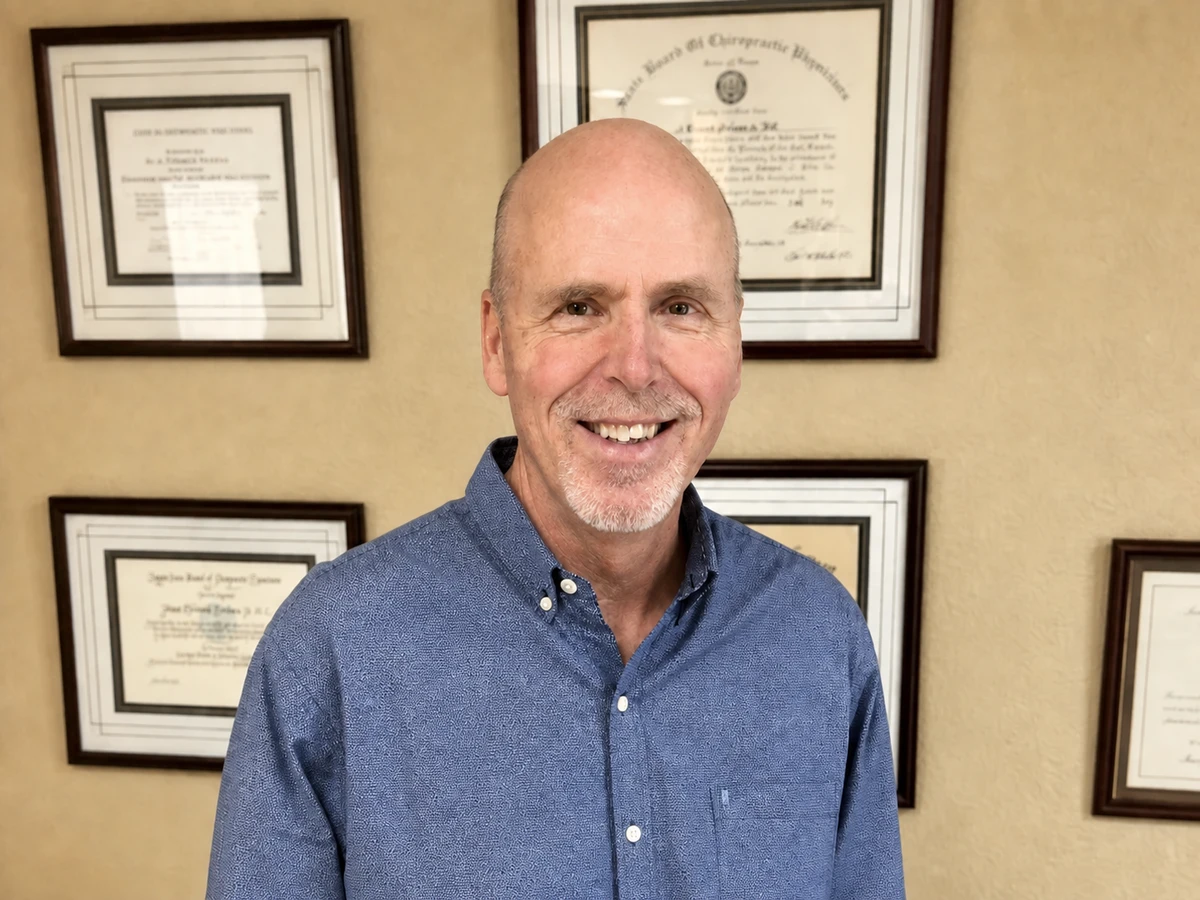 Dr J Edward Perkins smiling in his office